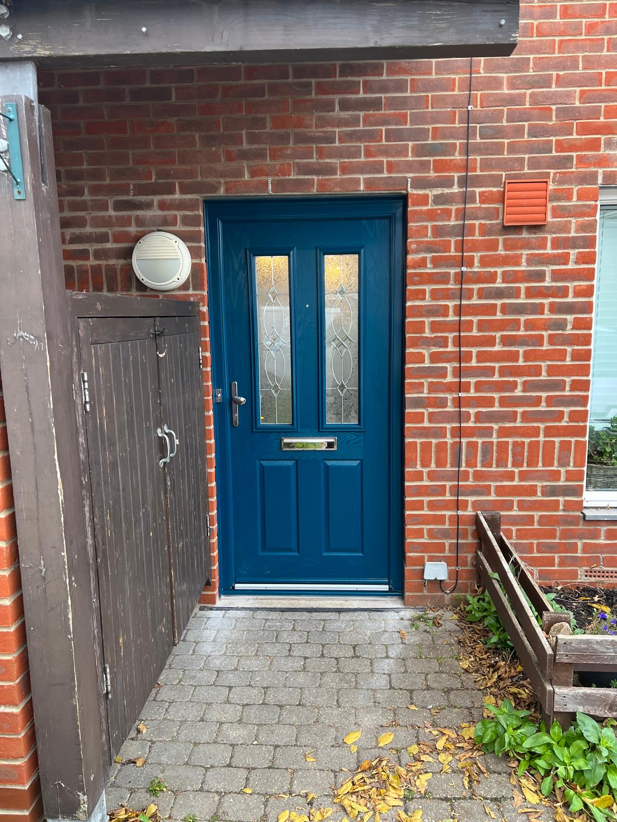 Blue composite front door with decorative glazing fitted near Cambridge