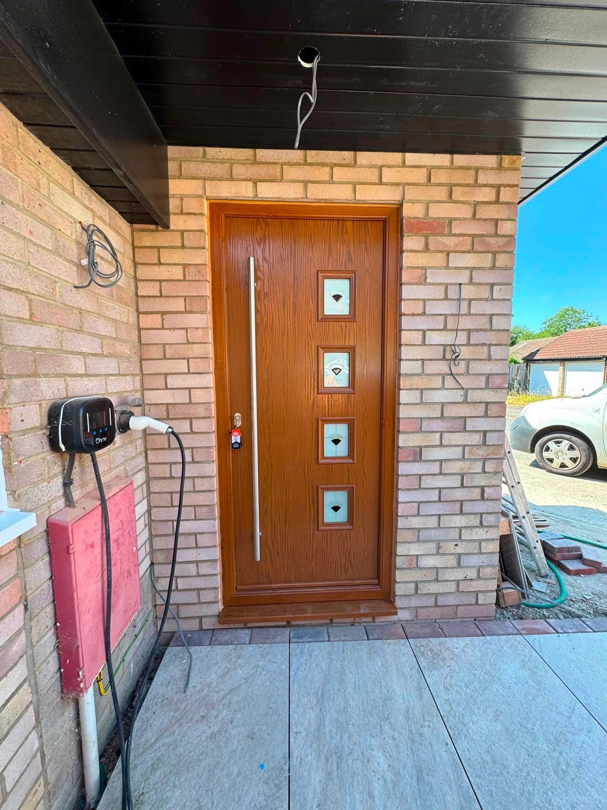 Oak-effect front door with long stainless handle fitted near Cambridge
