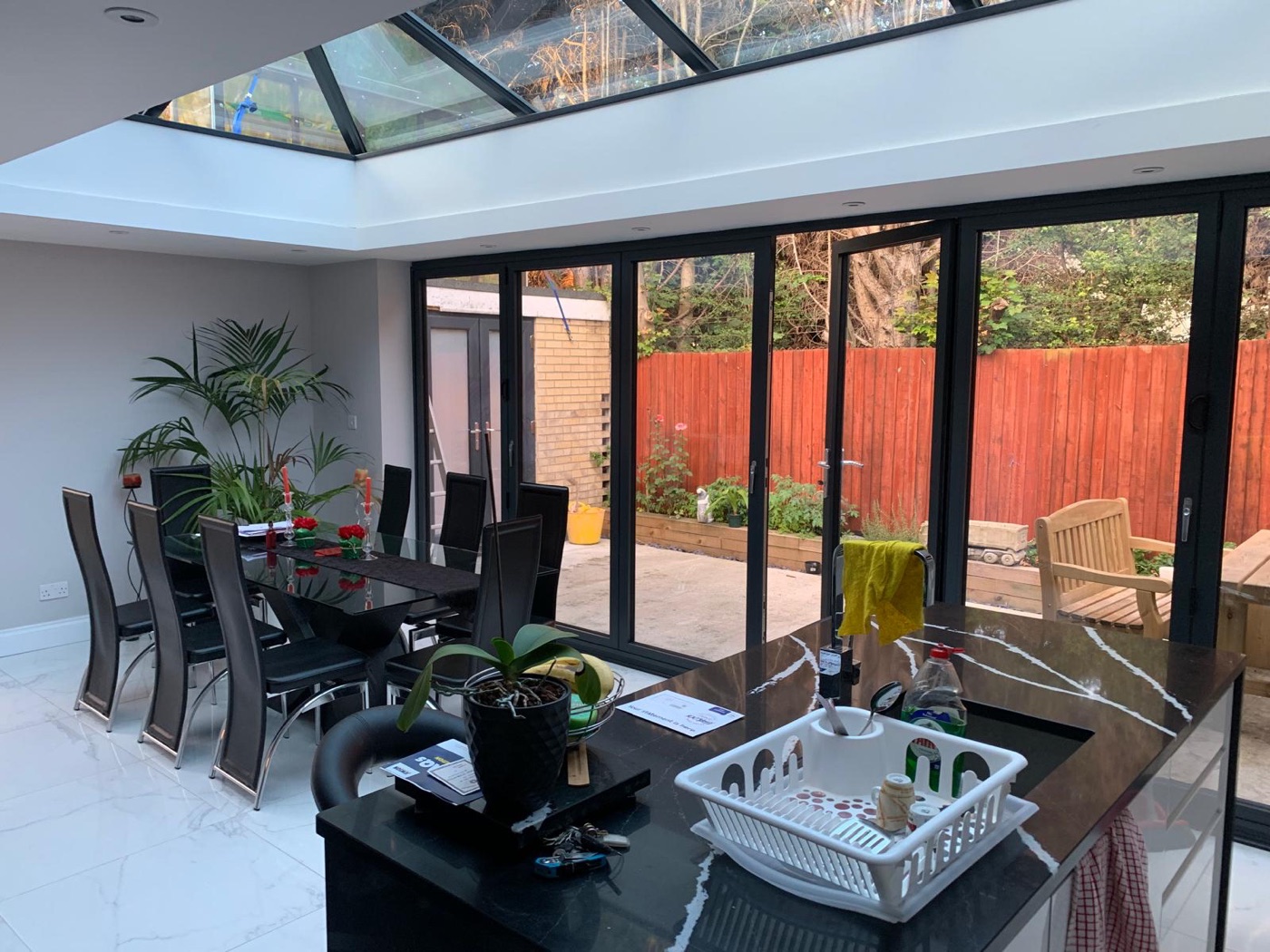 Bright open-plan extension with bifold doors and roof glazing