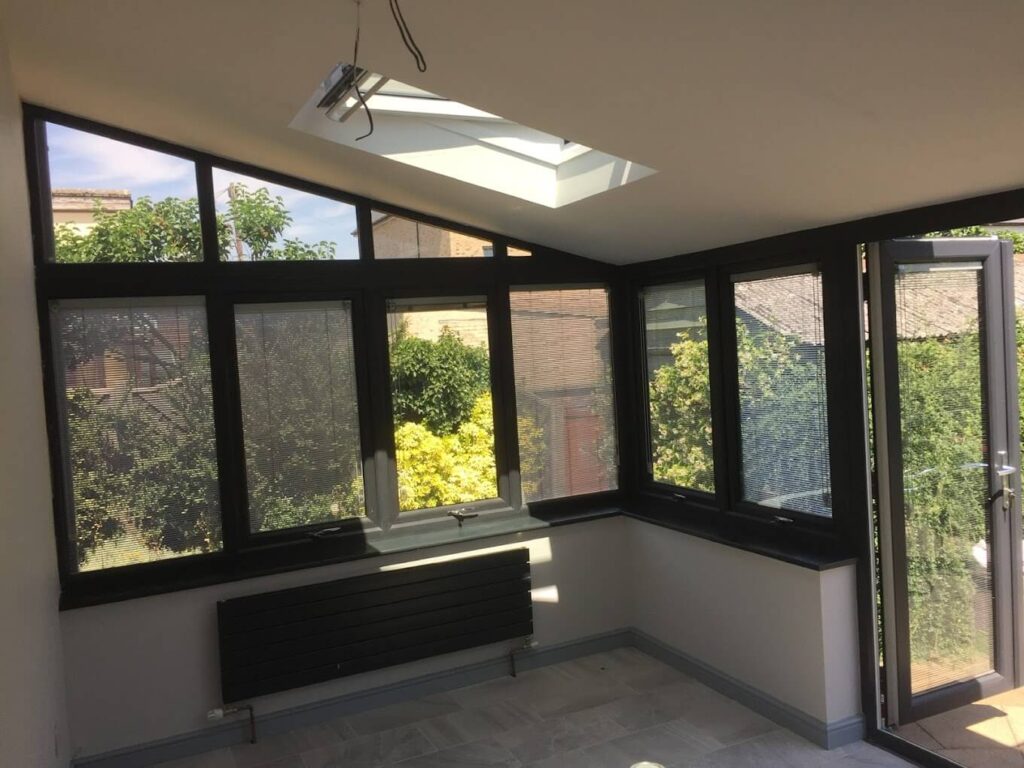 Conservatory interior with a solid insulated roof and skylight
