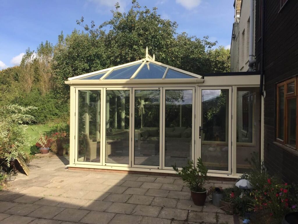 Cream conservatory with glazed roof on a paved patio