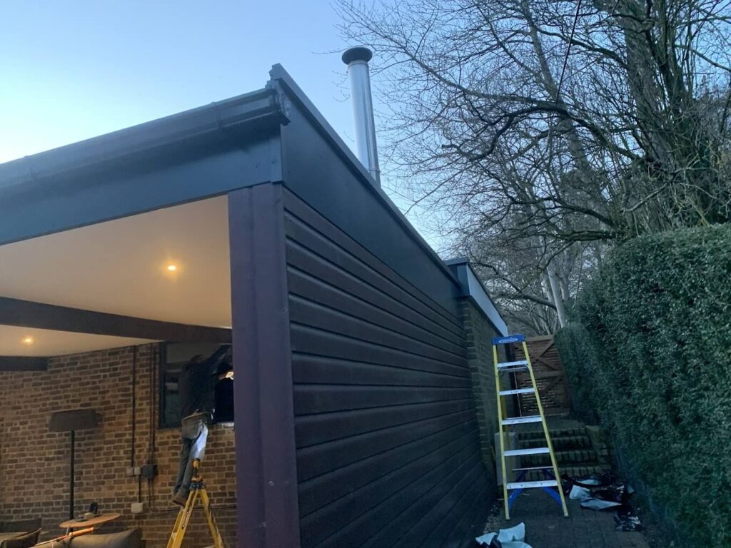 Dark-clad covered outdoor area under construction