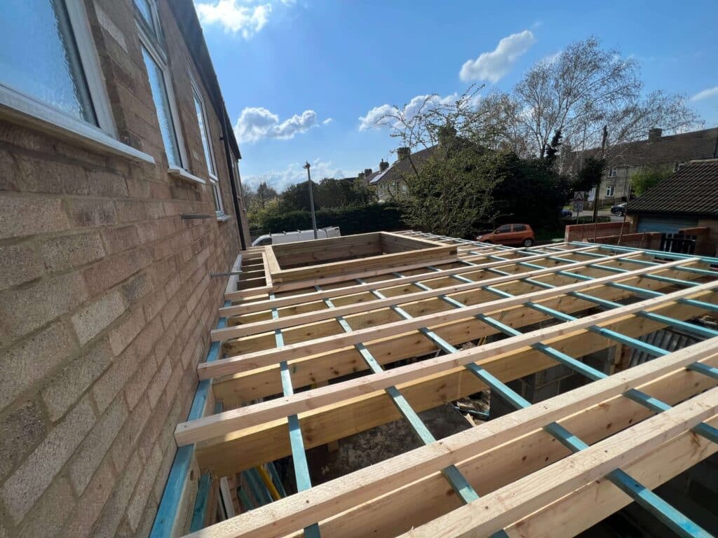 Timber joists for a new flat roof on a brick extension