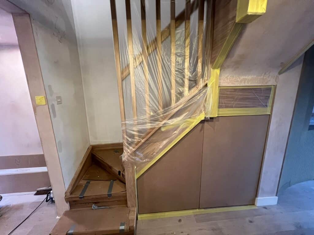 Oak staircase with a slatted oak balustrade and flush under-stairs cupboards
