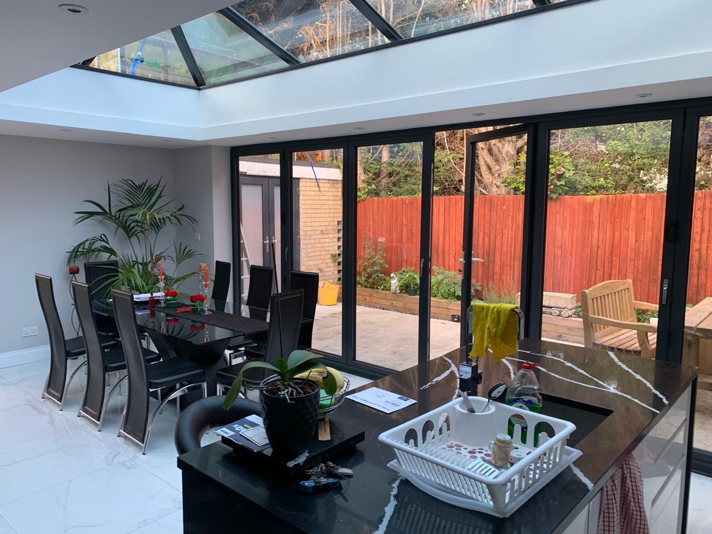 Bright open-plan extension with bifold doors and roof glazing