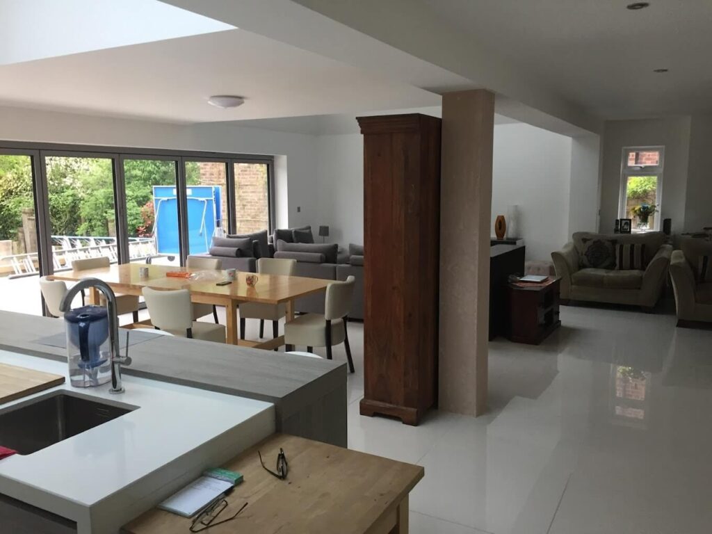 Open-plan kitchen and living space with large-format floor tiles