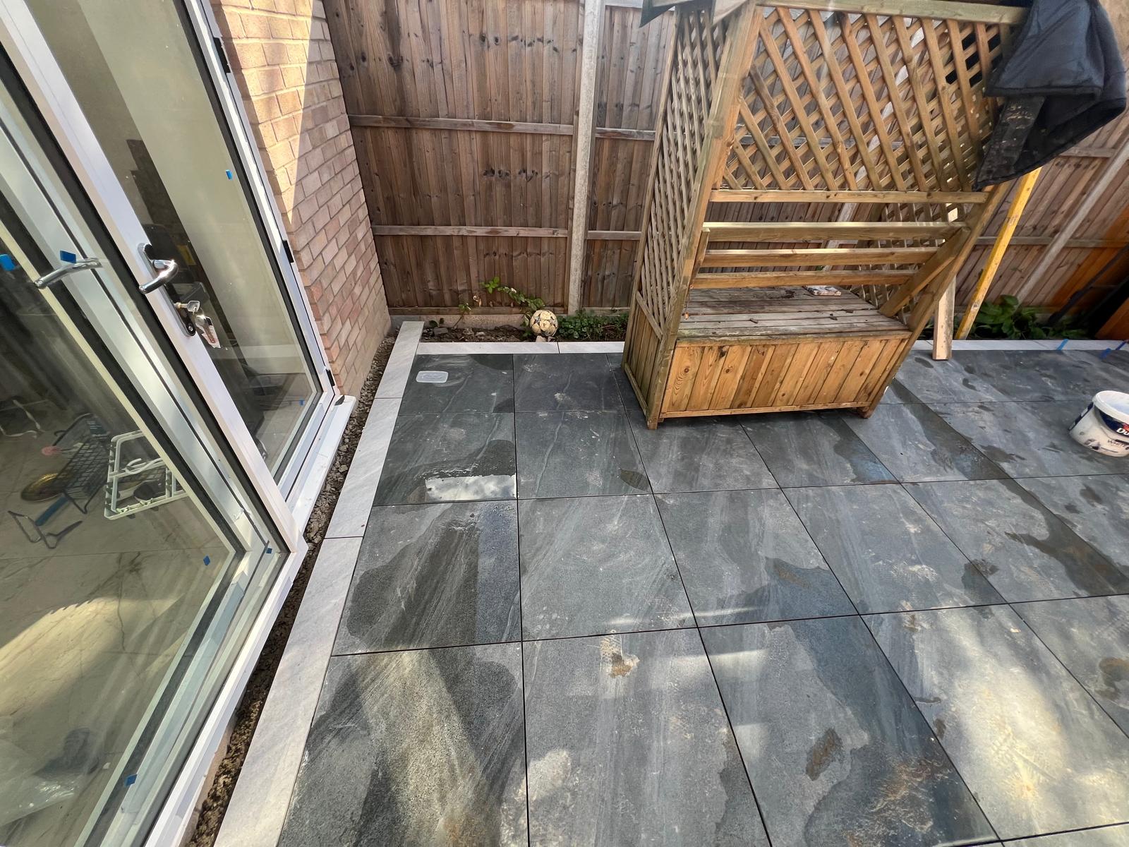 Detailed porcelain paving and contrasting border beside patio doors