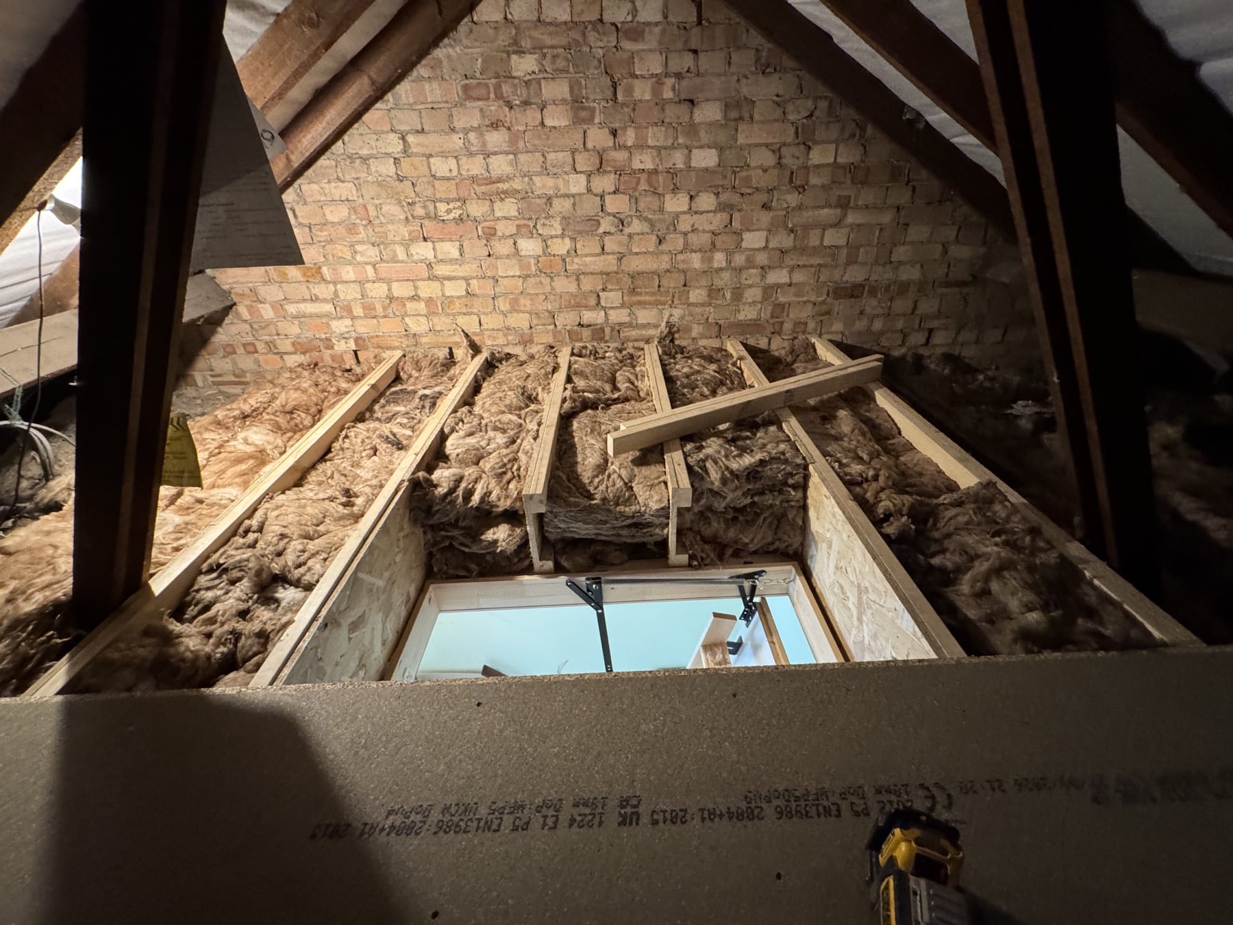 Timber supports and insulation around the loft access opening