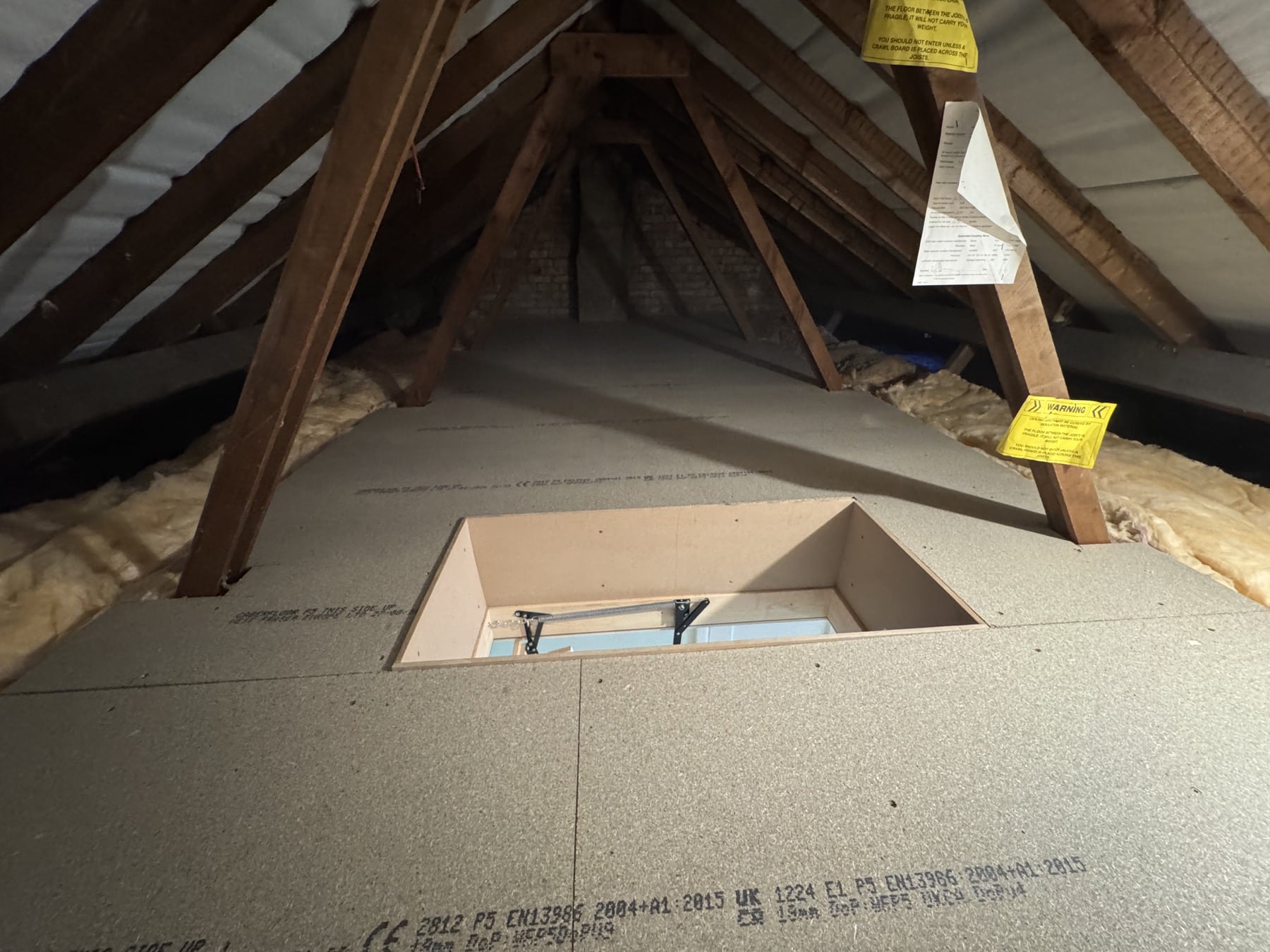 Framed loft hatch with compact access ladder visible below